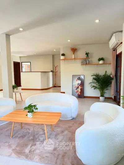 Stylish modern living room with cozy white sofas and elegant decor