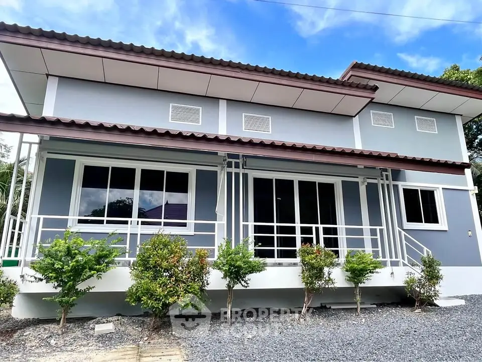 Modern two-story house with sleek design and lush greenery, perfect for contemporary living.