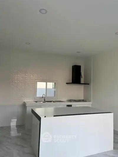 Modern kitchen with sleek white countertops and minimalist design