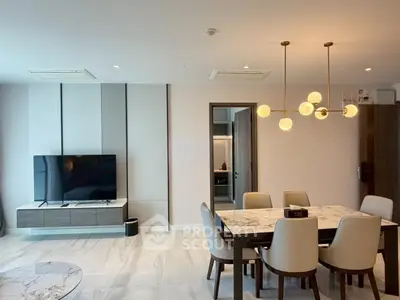 Modern living room with elegant dining area and stylish lighting in a contemporary apartment.