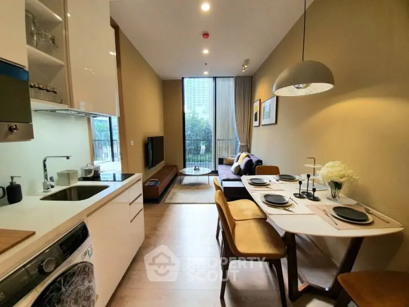 Modern open-plan kitchen and living room with stylish decor and city view.