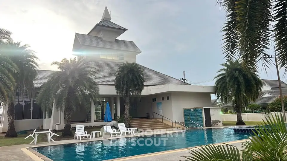 Luxurious property with a stunning pool and palm trees, perfect for relaxation and leisure.