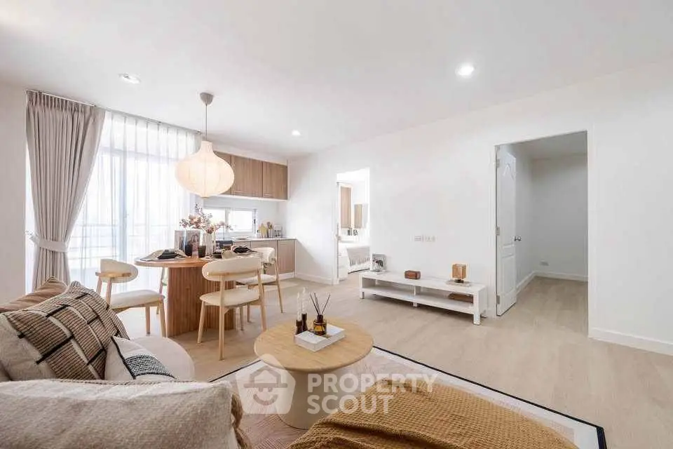 Modern open-plan living room with cozy dining area and natural light