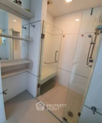 Modern bathroom with glass shower enclosure and sleek fixtures