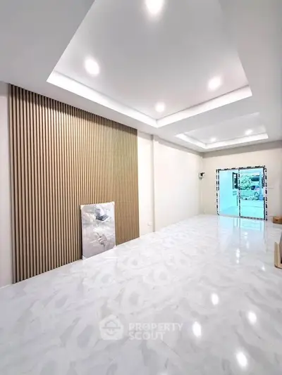 Spacious modern living room with elegant ceiling lights and marble flooring