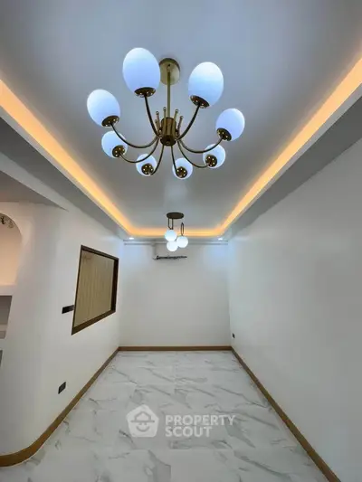 Elegant living room with modern chandelier and marble flooring