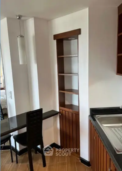 Cozy kitchen corner with wooden shelves and modern sink