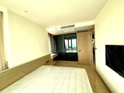 Spacious bedroom with modern design and large window offering a stunning view.