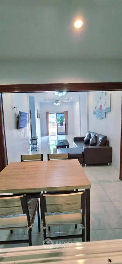 Spacious living room with modern furniture and large windows offering natural light.