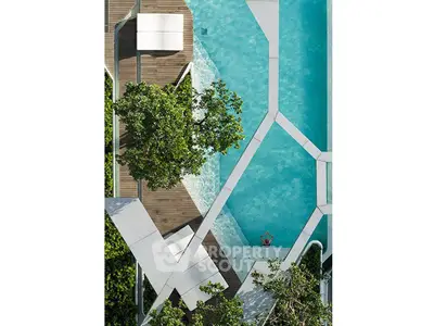 Stunning aerial view of a modern geometric swimming pool surrounded by lush greenery.