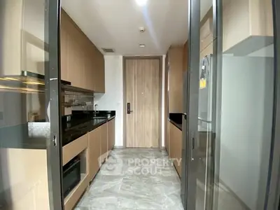 Modern kitchen with sleek cabinetry and built-in appliances in a stylish apartment.