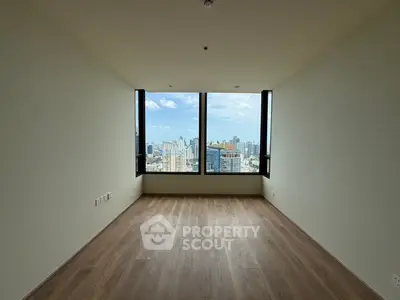 Spacious empty room with stunning city view through large windows, perfect for customization.