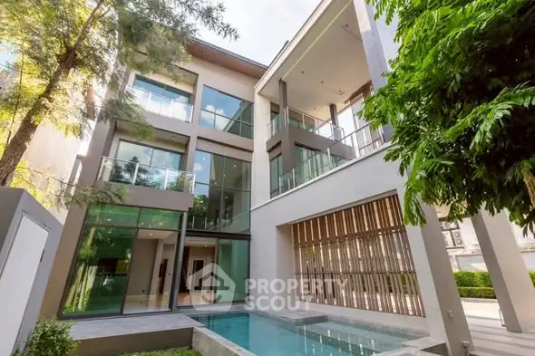 Luxurious modern villa with private pool and expansive glass facade.