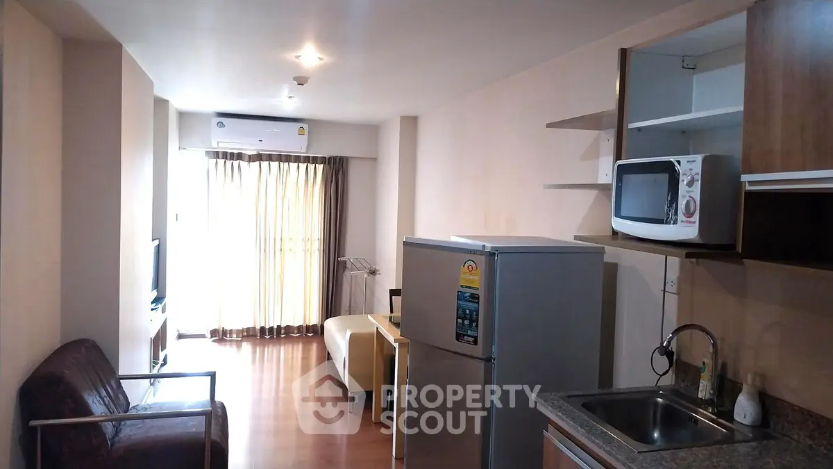 Modern apartment interior with open layout kitchen and cozy living area.