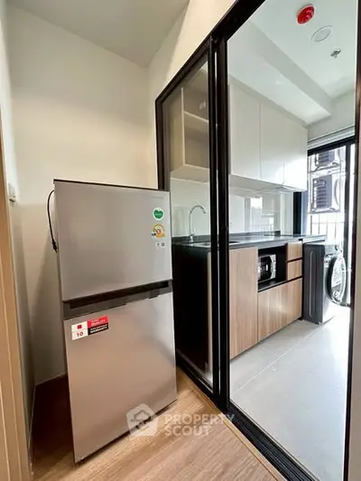 Modern kitchen with sleek appliances and sliding glass door