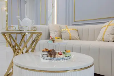 Luxurious living room with elegant sofa and stylish coffee tables, perfect for sophisticated gatherings.