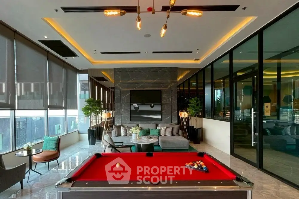 Luxurious modern living room with pool table and panoramic city views.