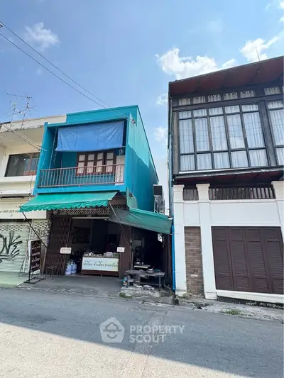 Charming urban building with colorful facade and street view, perfect for commercial or residential use.