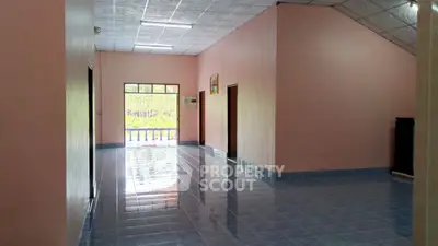 Spacious interior with glossy blue tiles and pink walls, ample natural light