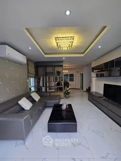 Luxurious living room with modern decor, elegant ceiling design, and spacious layout.