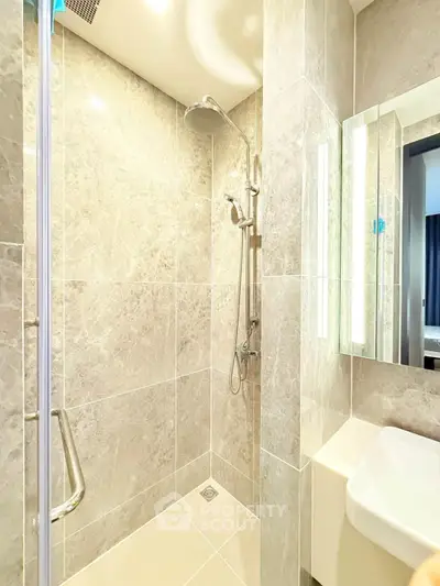 Modern bathroom with sleek shower and elegant marble tiles