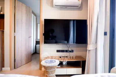 Modern living room with wall-mounted TV and air conditioning unit