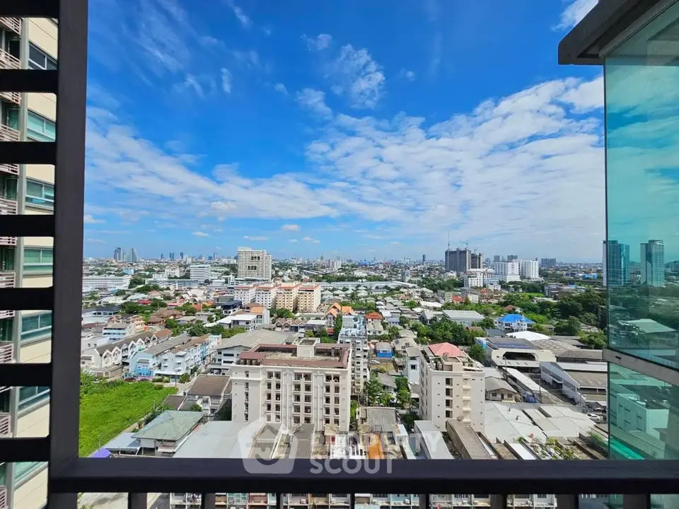 Stunning cityscape view from high-rise balcony with clear blue sky