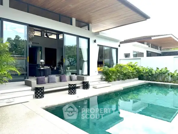 Luxurious modern villa with private pool and stylish outdoor seating area, perfect for relaxation and entertainment.