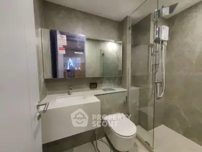 Modern bathroom with sleek design featuring glass shower and stylish vanity.