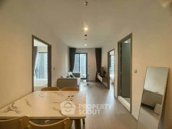 Modern open-plan living and dining area with stylish decor and natural light.