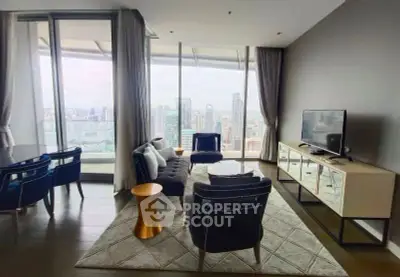 Luxurious living room with stunning city view, modern furniture, and floor-to-ceiling windows in high-rise apartment.