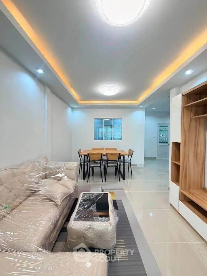Modern living room with elegant ceiling lights and stylish dining area