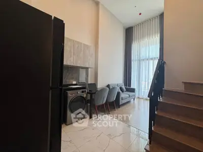 Modern duplex living room with high ceilings and stylish furniture