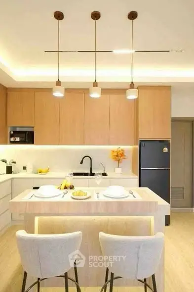 Modern kitchen with island, pendant lights, and sleek cabinetry