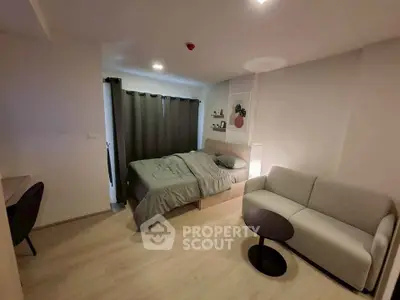 Modern studio apartment with cozy bed and stylish sofa