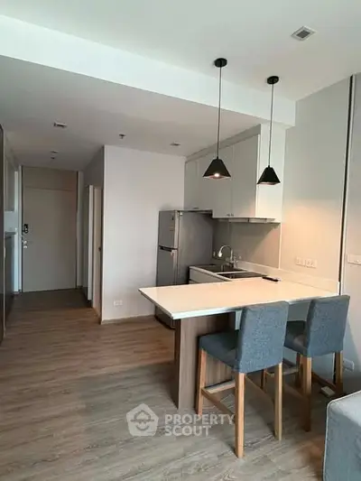Modern kitchen with sleek design and breakfast bar in a stylish apartment.