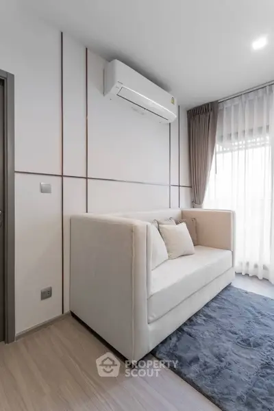 Modern living room with sleek air conditioning and plush sofa