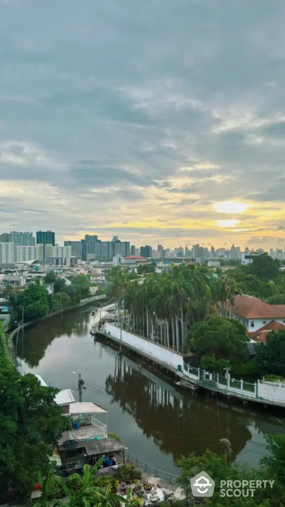 Stunning cityscape view with river and lush greenery at sunset