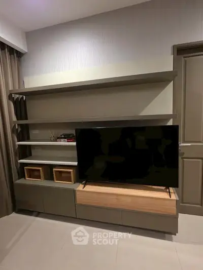 Modern living room with sleek TV stand and shelves, perfect for stylish urban living.