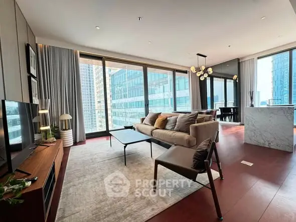 Luxurious modern living room with floor-to-ceiling windows and elegant decor in a high-rise apartment.