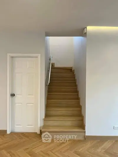 Modern interior with wooden staircase and white walls in a stylish home