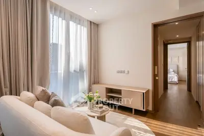 Elegant living room with natural light and modern decor in a stylish apartment.