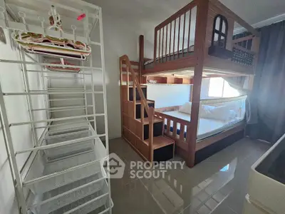 Spacious bedroom with stylish wooden bunk bed and ample storage space.