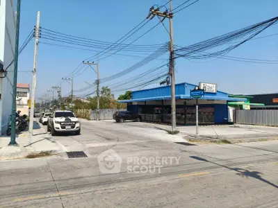 Commercial property with ample parking space and street view in a bustling area.