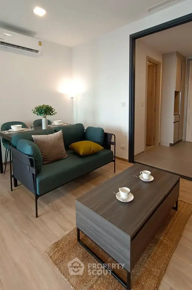 Modern living room with stylish furniture and cozy dining area in a contemporary apartment.