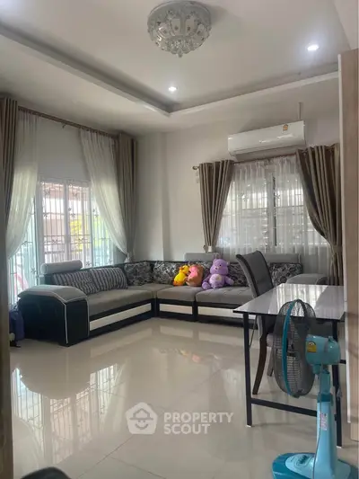Spacious living room with modern decor and large windows for natural light.