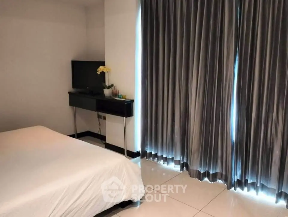 Modern bedroom with sleek design and elegant curtains