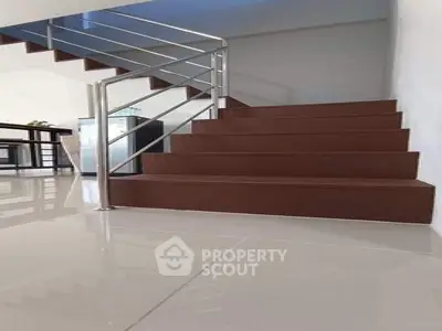 Modern staircase with sleek design and polished flooring in a contemporary home.