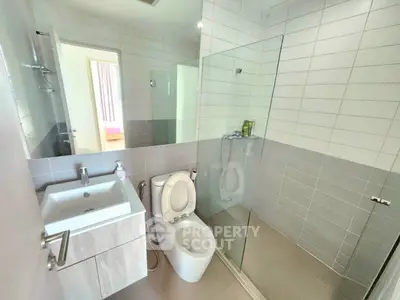 Modern bathroom with glass shower and sleek fixtures