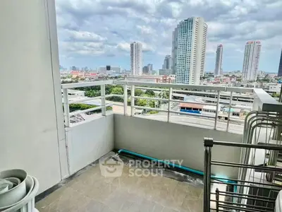 Spacious balcony with stunning city skyline view in modern high-rise apartment.